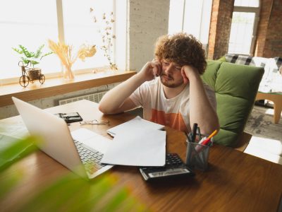 Caucasian upset and despair man watching financial and economical graphs going down